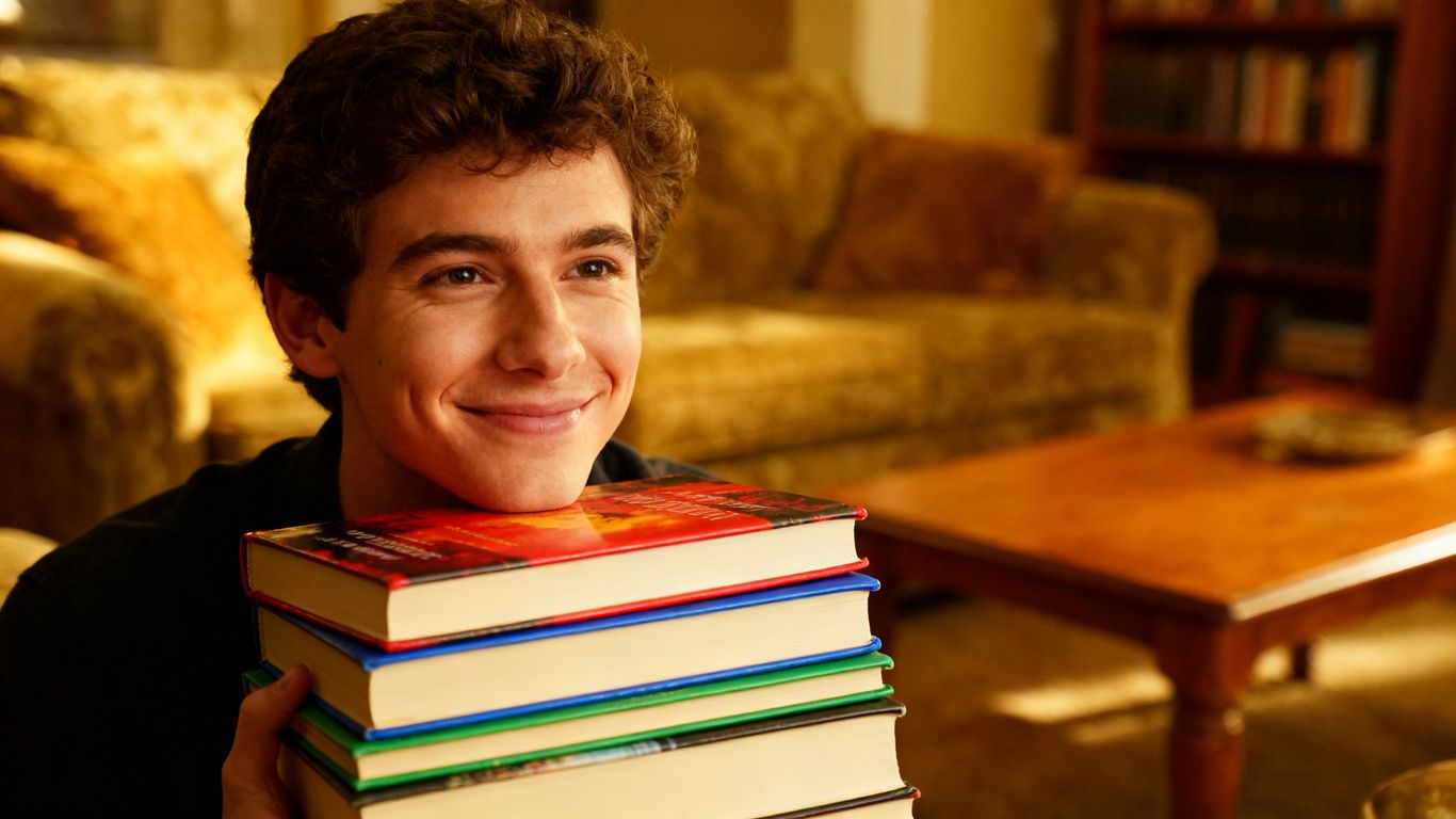 Person holding a stack of books from in-laws.