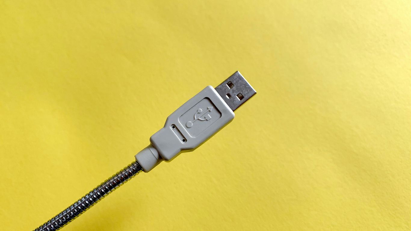 white usb cable plugged in white power outlet