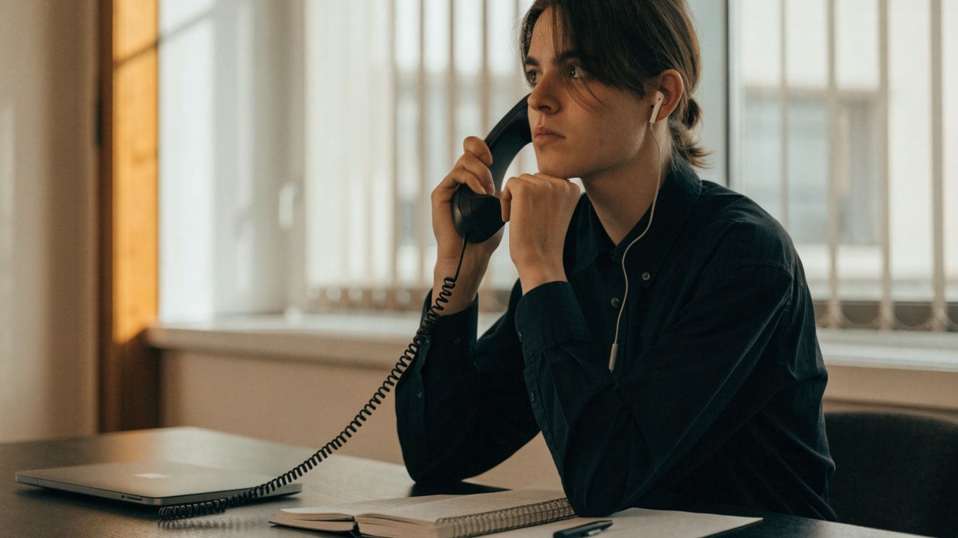Customer considering a phone call in a quiet office