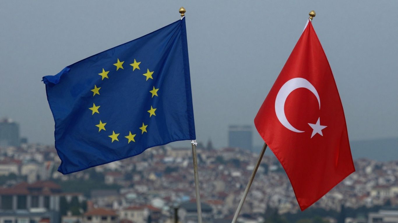 EU and Turkish flags together, cityscape background.