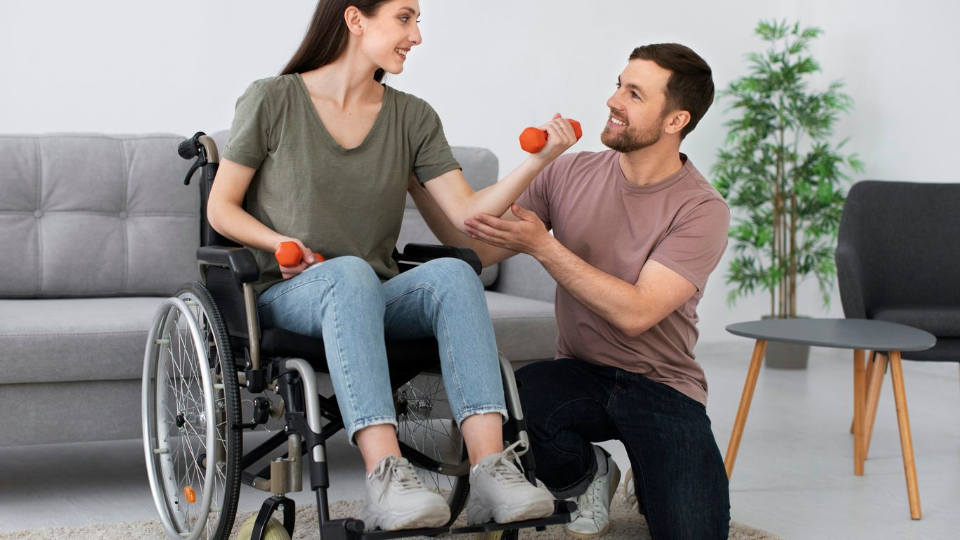 A man in a wheel chair being pushed by a woman