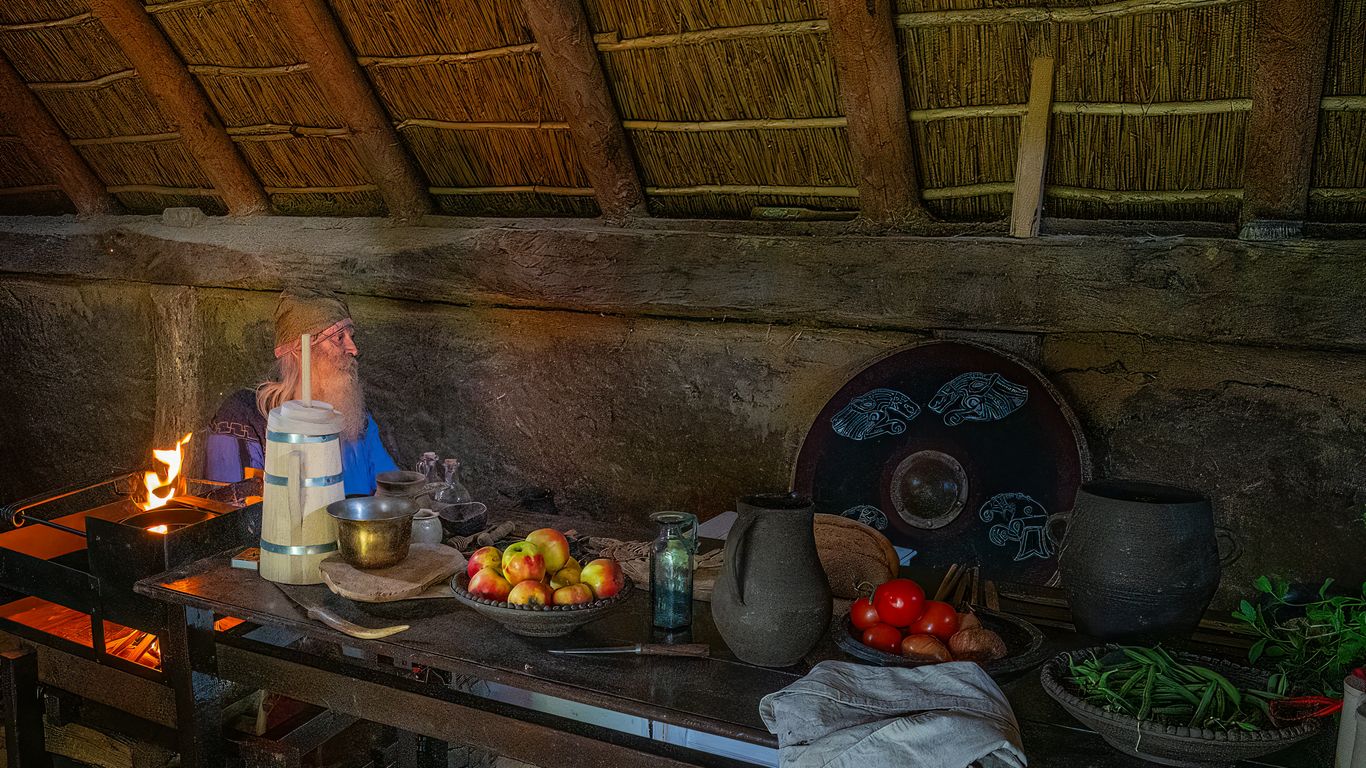 Rustic kitchen counter with food and cooking fire.