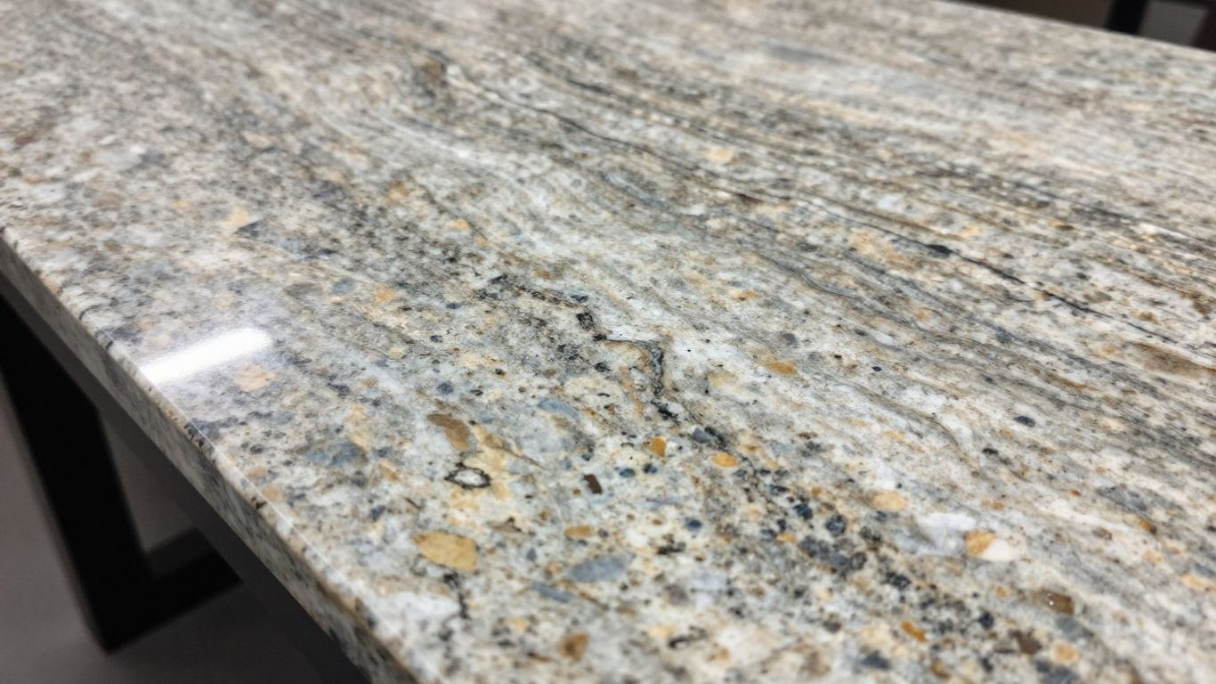 Polished granite countertop slab with natural patterns.