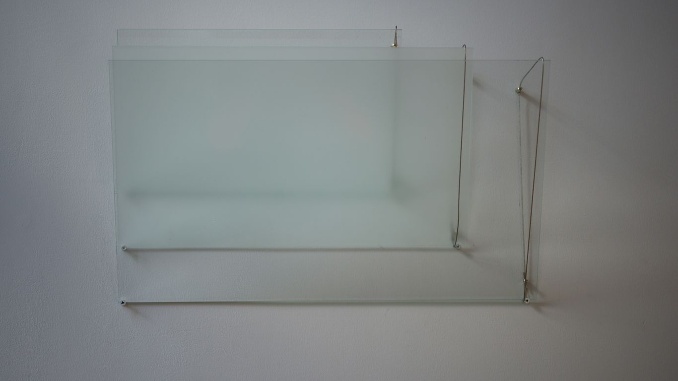 A white shelf with a glass shelf on top of it