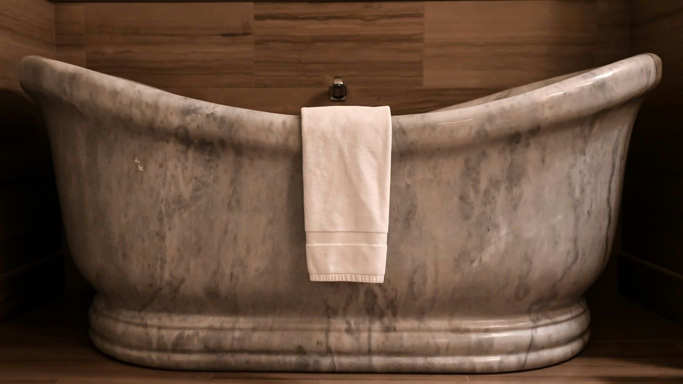 Sculptural marble bath in a bright bathroom
