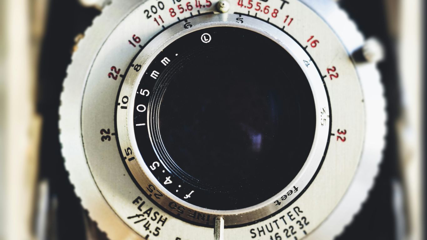 The focus is on a camera lens during production