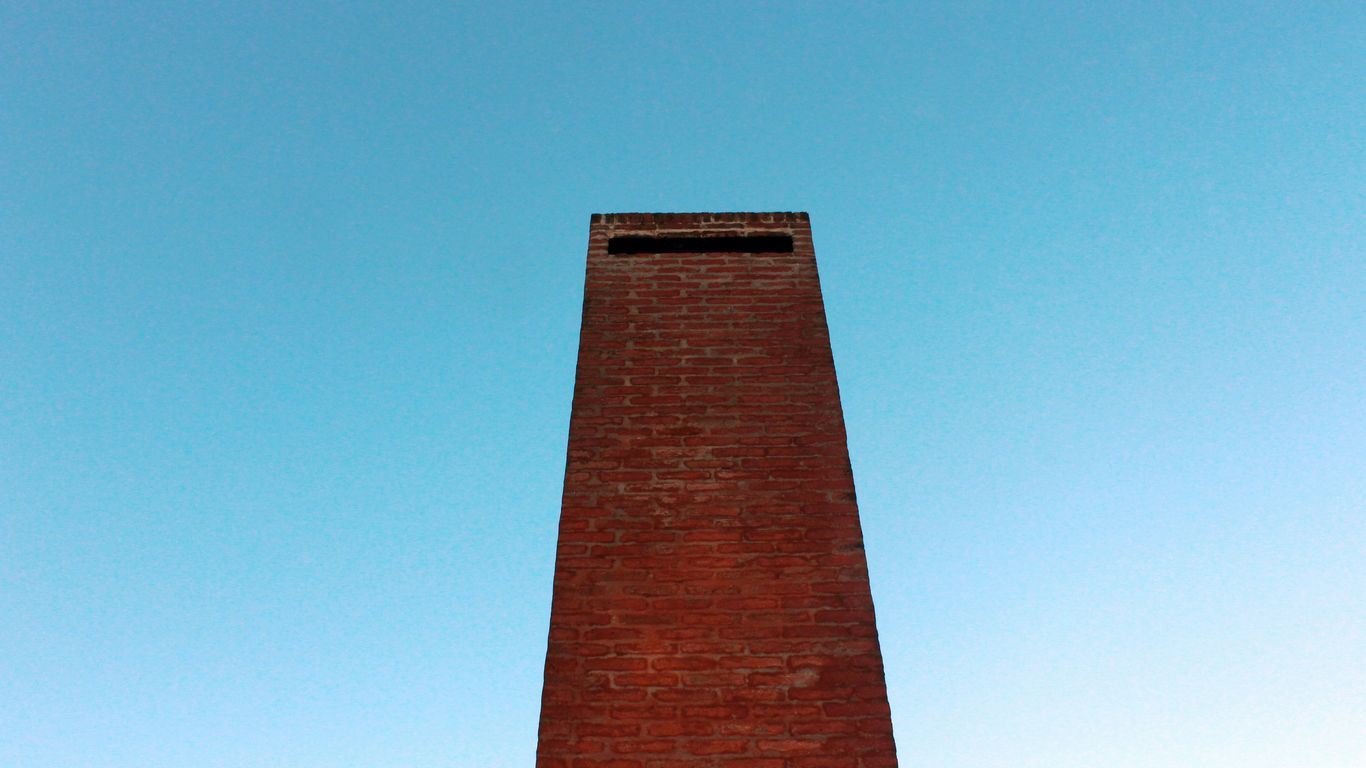 a tall brick tower with a clock on top