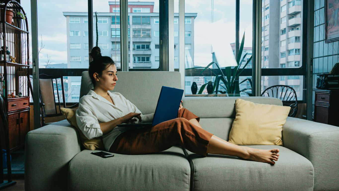 woman in white long sleeve shirt sitting on white couch