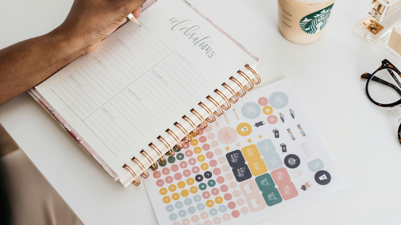 person writing at the tale