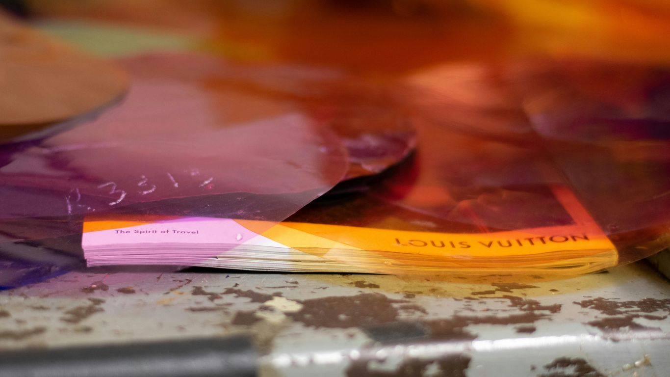 pink and yellow book on black and white table