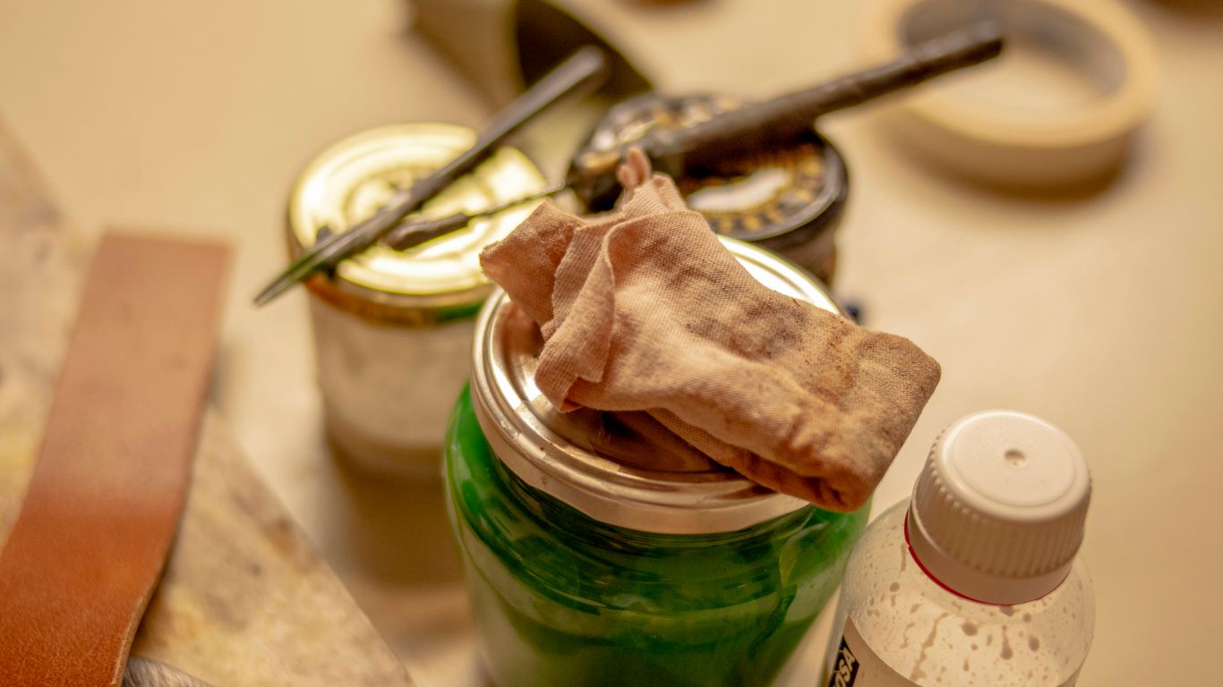 a jar of green stuff sitting on top of a table