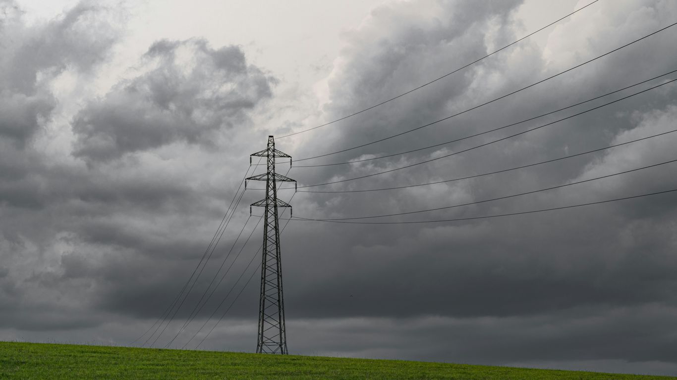 green grass field under cloudy sky