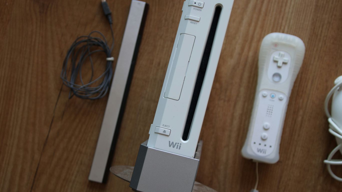 a nintendo wii game system sitting on top of a wooden table