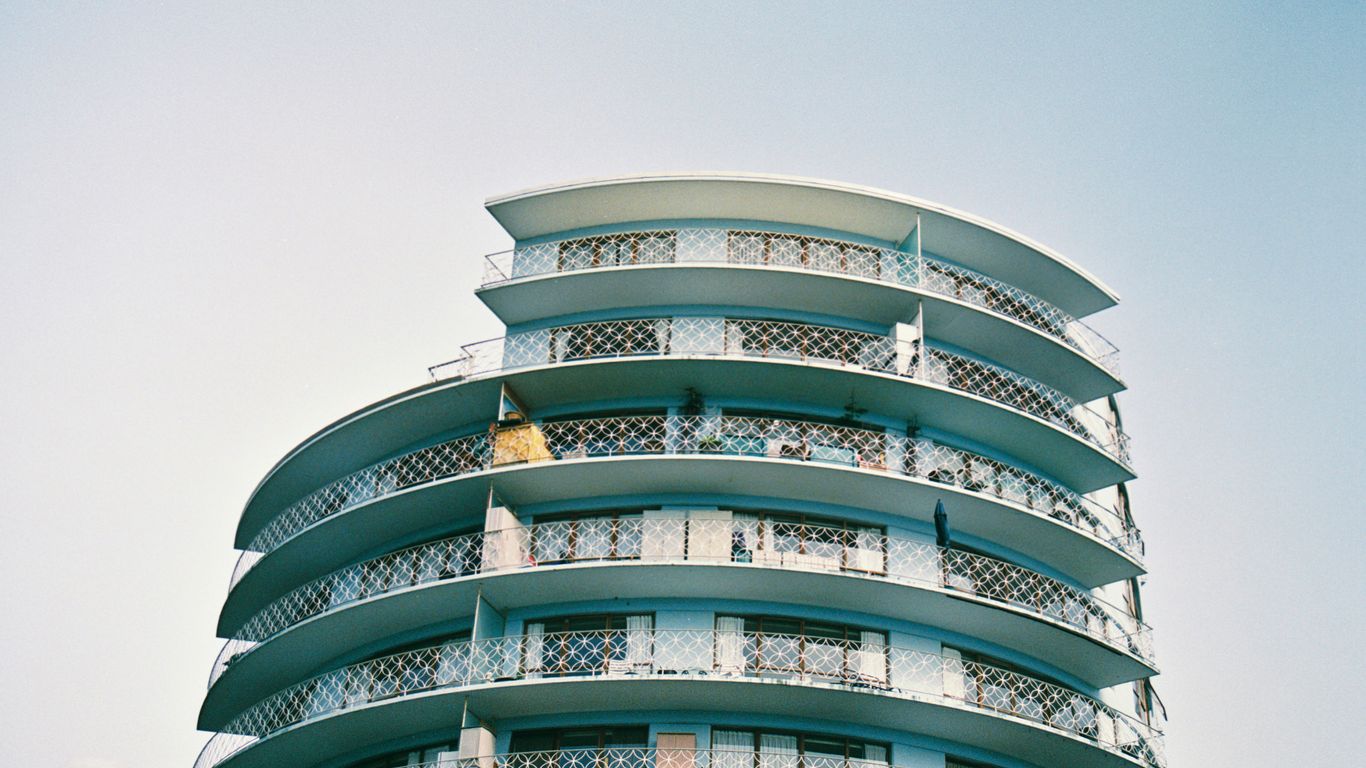 Curved historic flats beneath tropical trees
