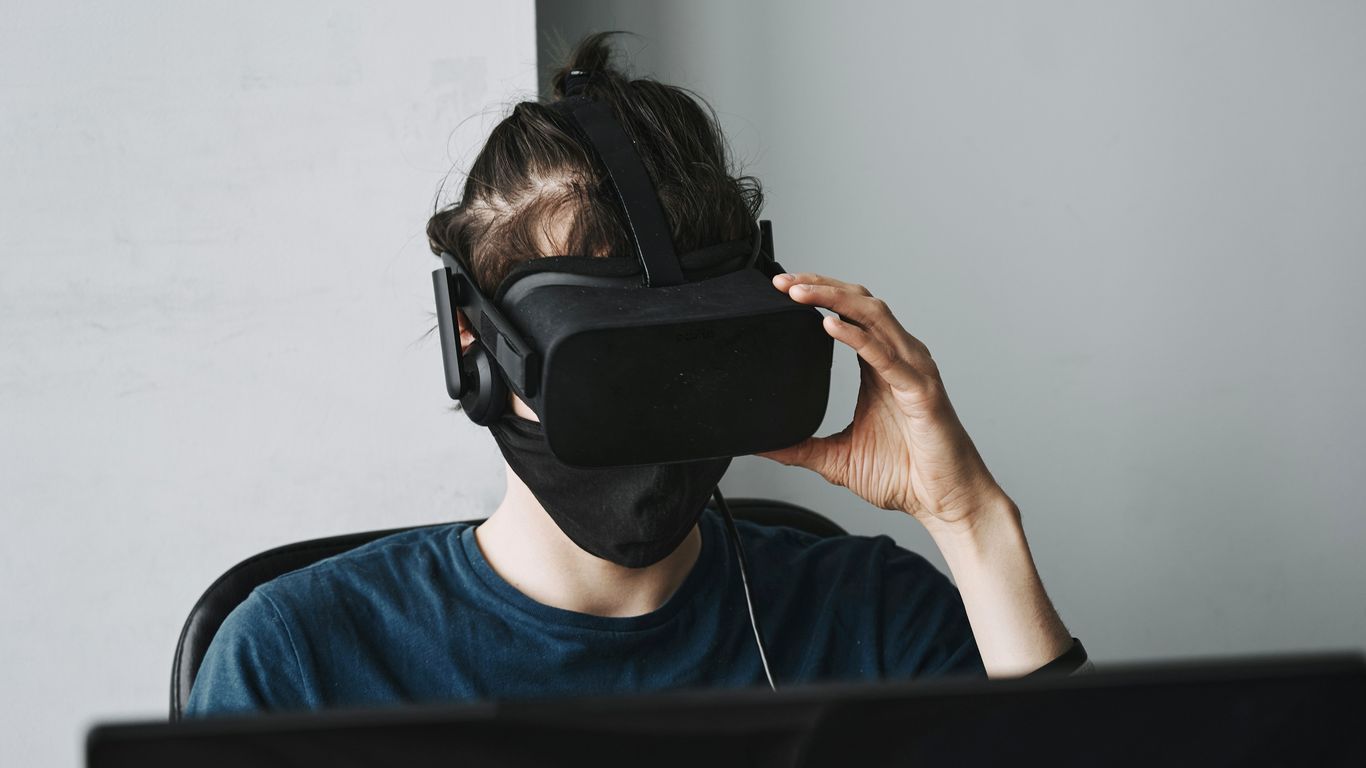 man in blue crew neck shirt wearing black vr goggles
