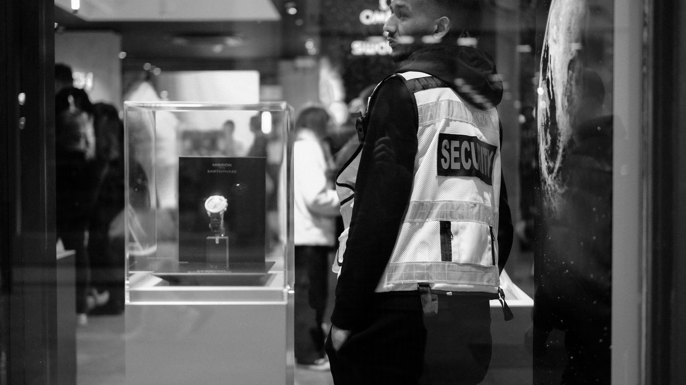Security guard wearing a reflective vest in a store.