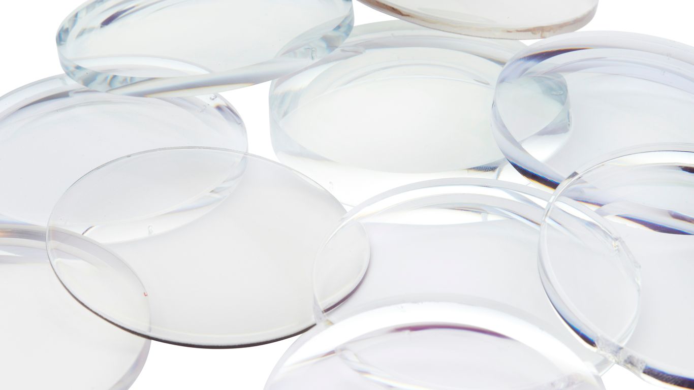 Optical lenses and inspection tools