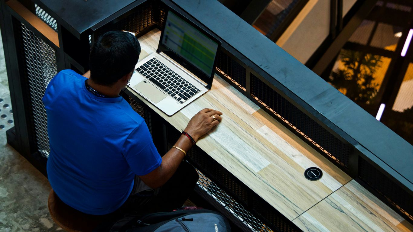 man using laptop on desk