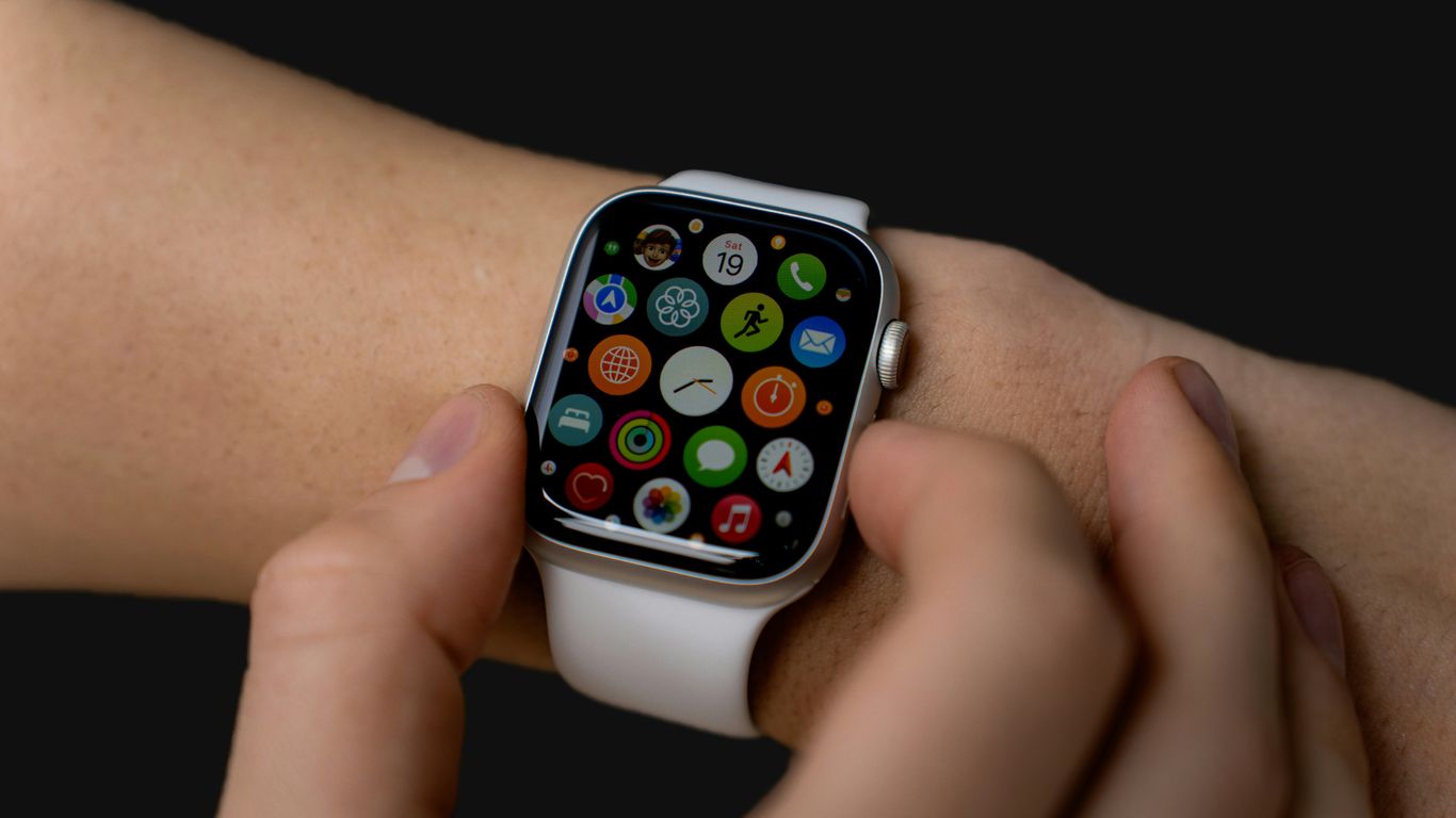 a close up of a person holding an apple watch