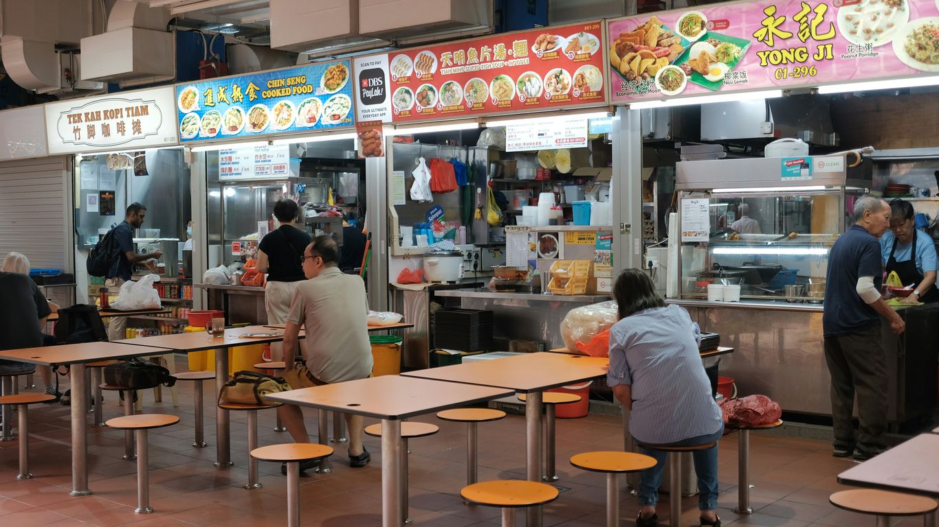 A group of people sitting at tables in a restaurant