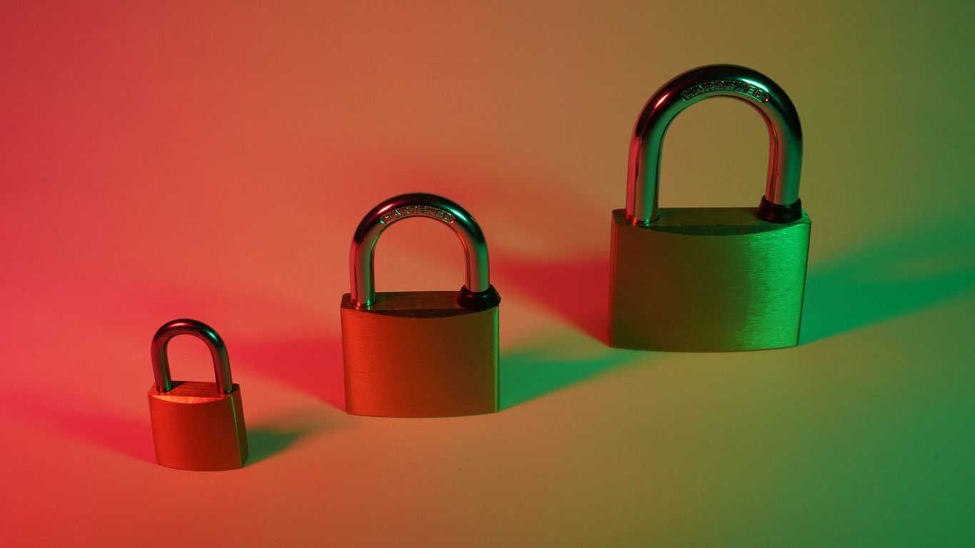 two brown padlock on pink surface