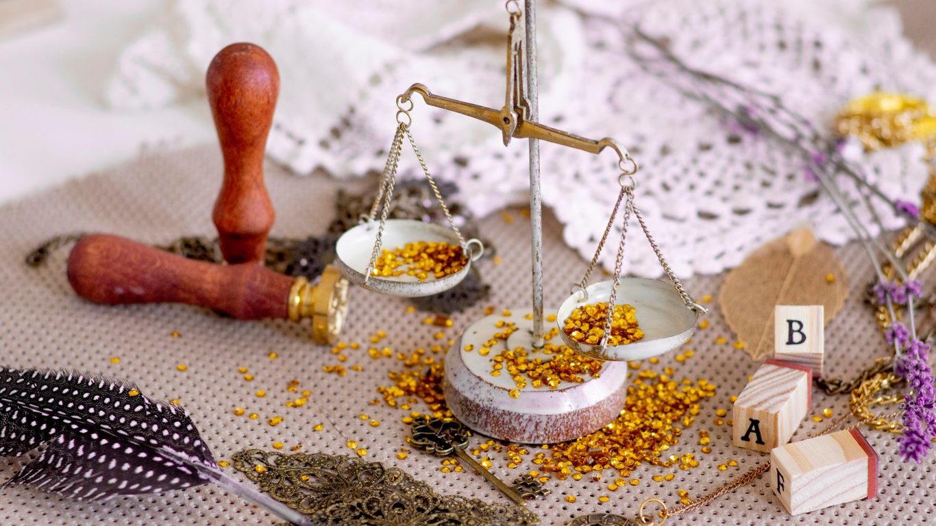 person in black and white sock sitting on white and brown floral area rug near silver