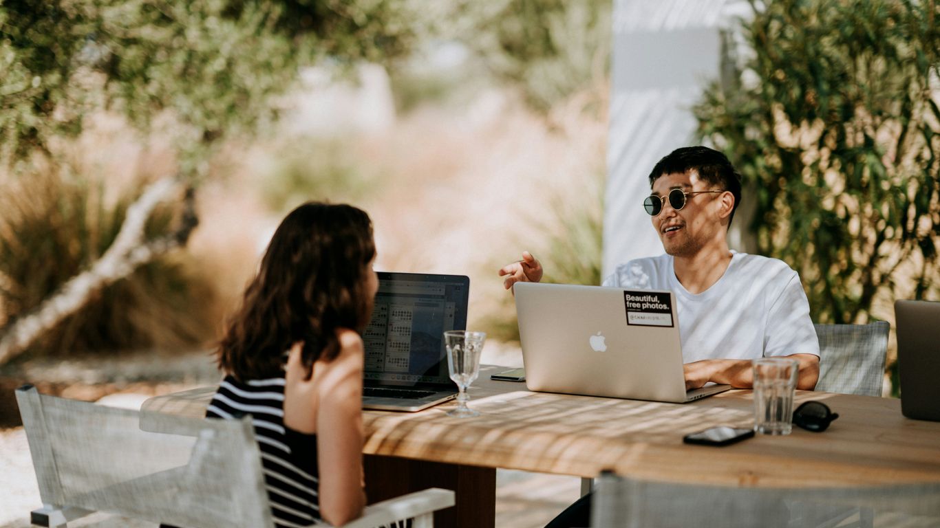 man and woman sitting outdoors