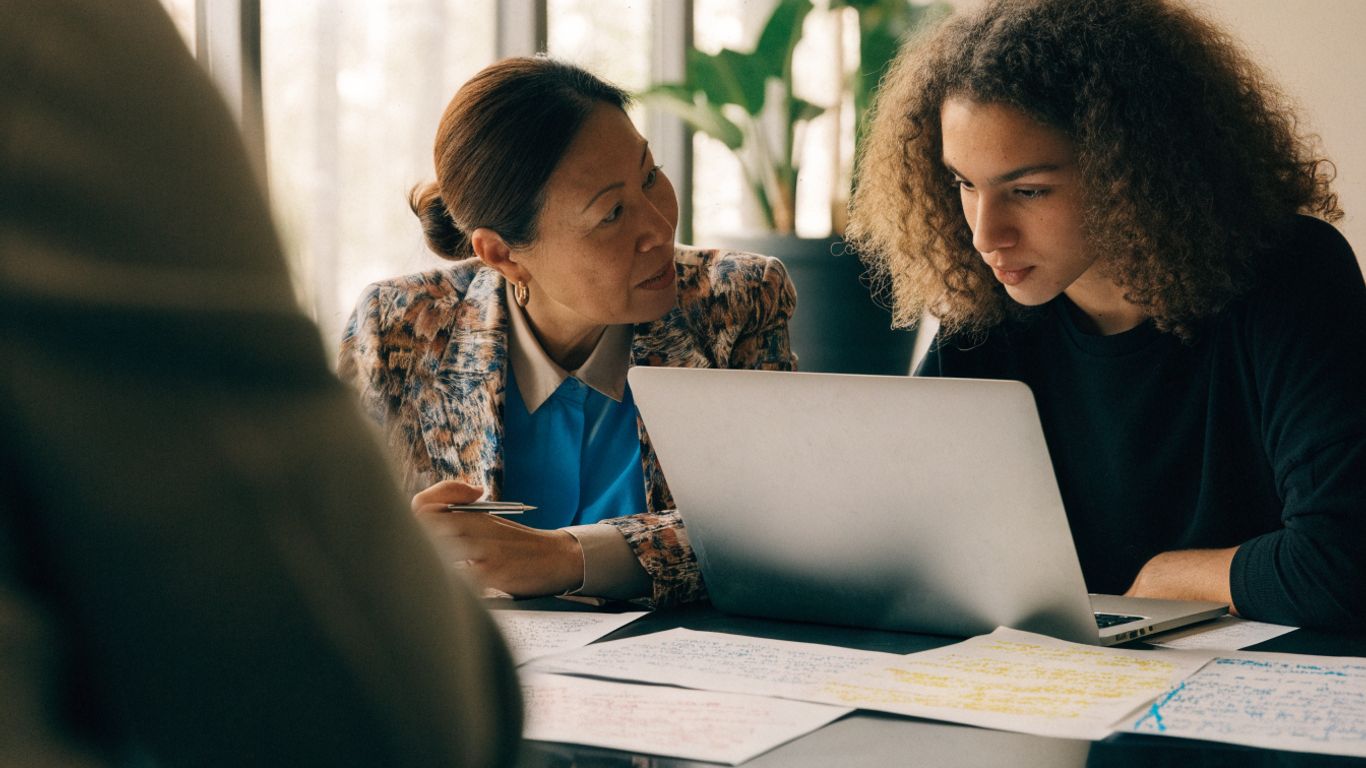 Host manager and assignee reviewing project notes