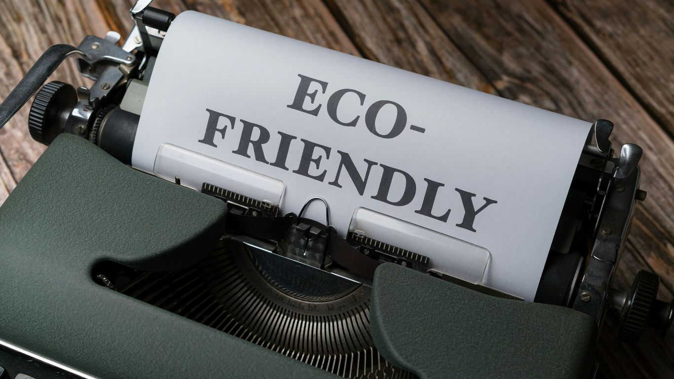 a close up of a typewriter with a paper that reads eco - friendly