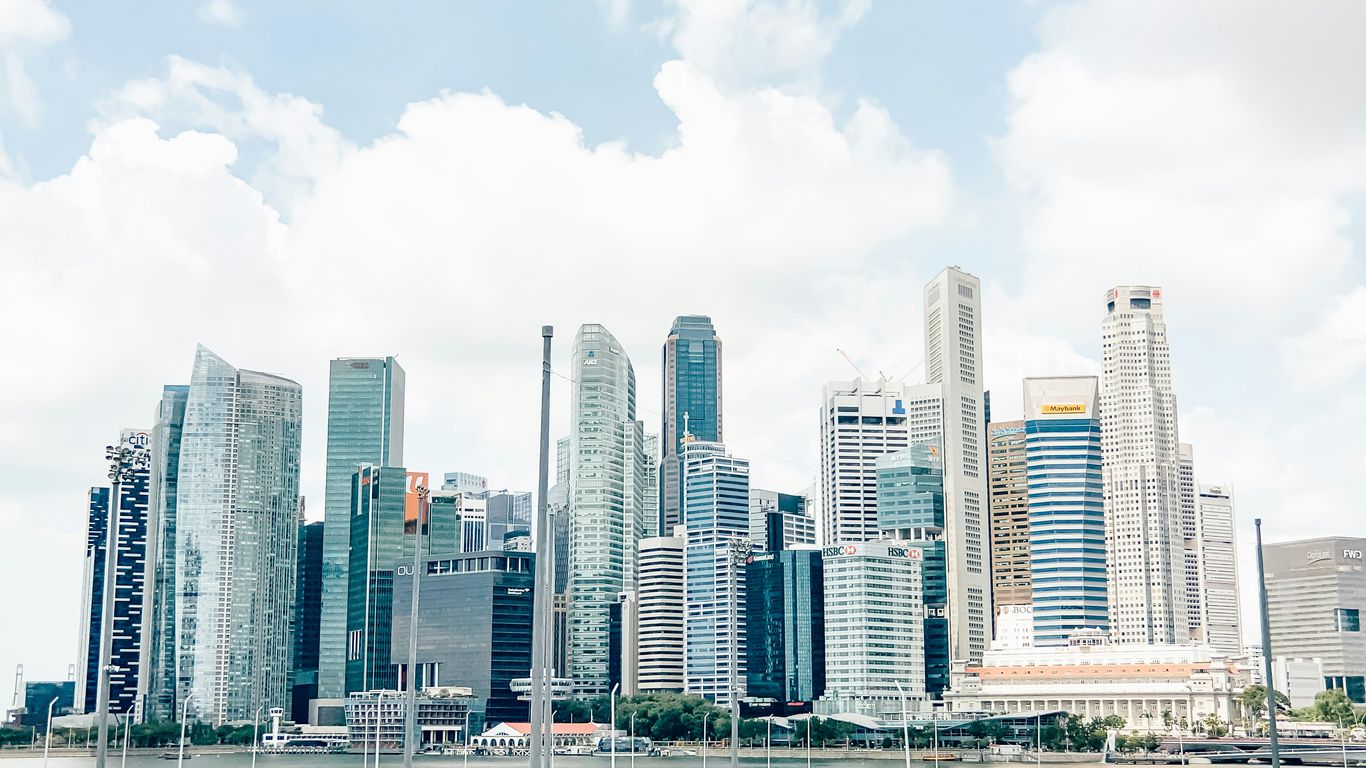 city skyline under white cloudy sky during daytime