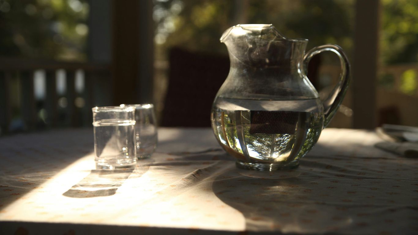 clear glass pitcher beside clear drinking glass on table