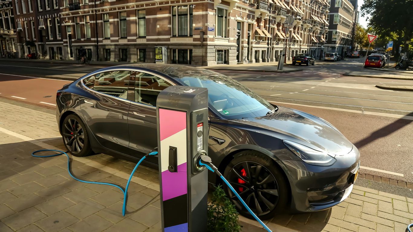 a car plugged into a charging station on a city street