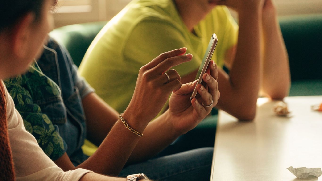Social media giveaway ideas. A cheerful quiz moment on a smartphone