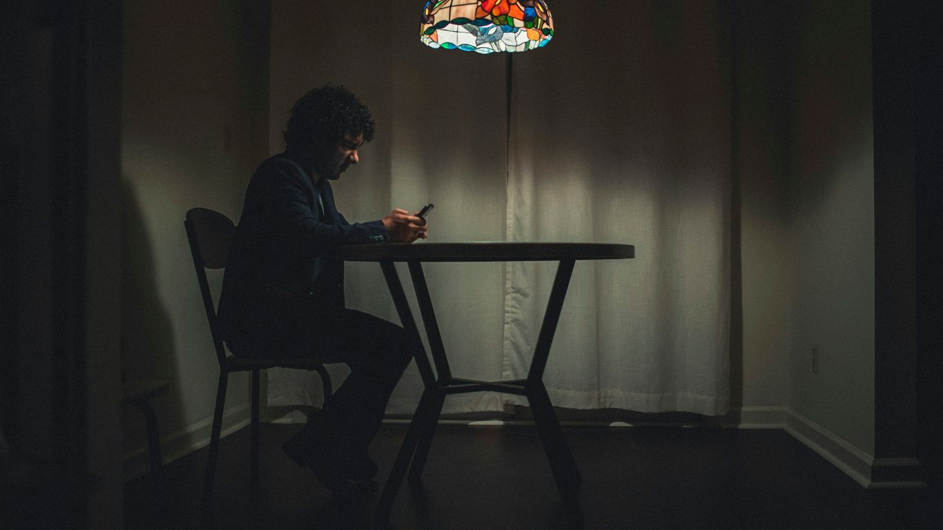 man in black shirt sitting on chair