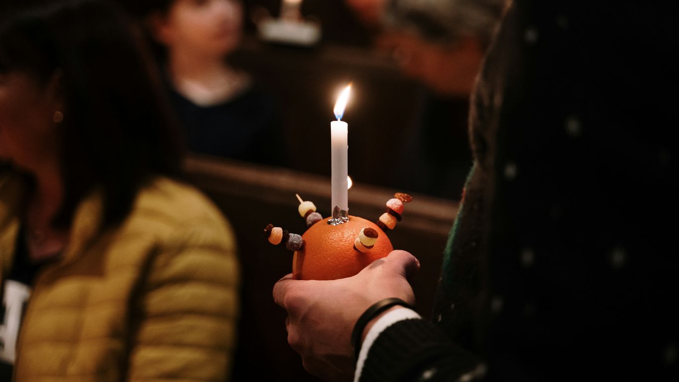 a person holding a candle in their hand