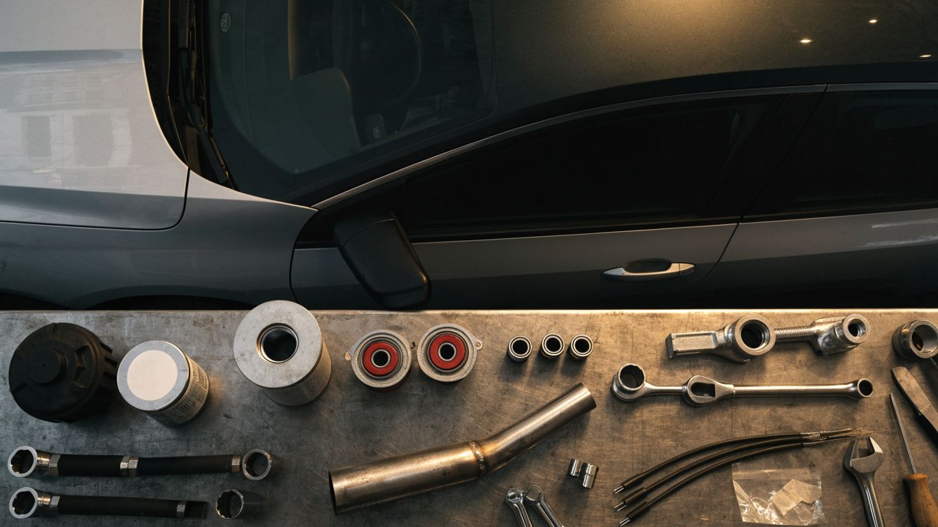 Audi parts and repair tools arranged in a workshop