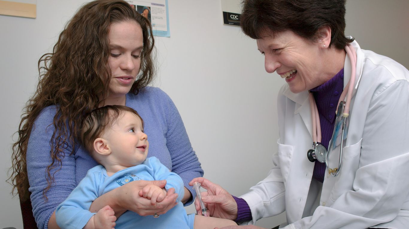 a young child is being examined by a doctor