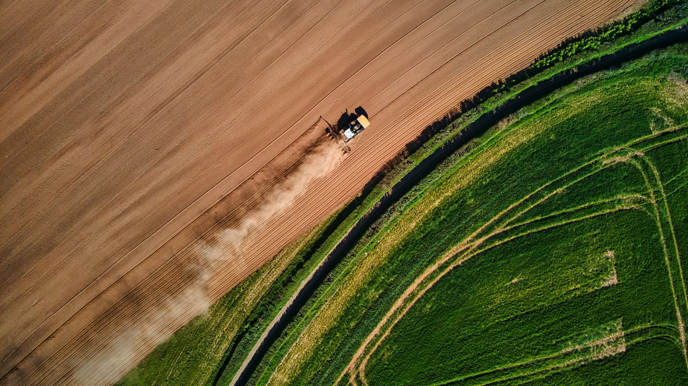 Autonomous tractor working across farmland
