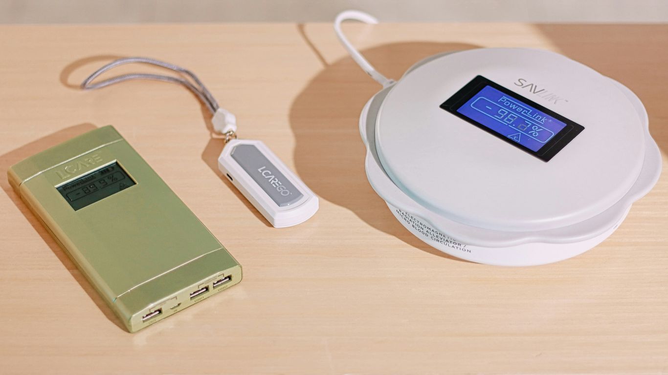 a white device with a screen and a white cord