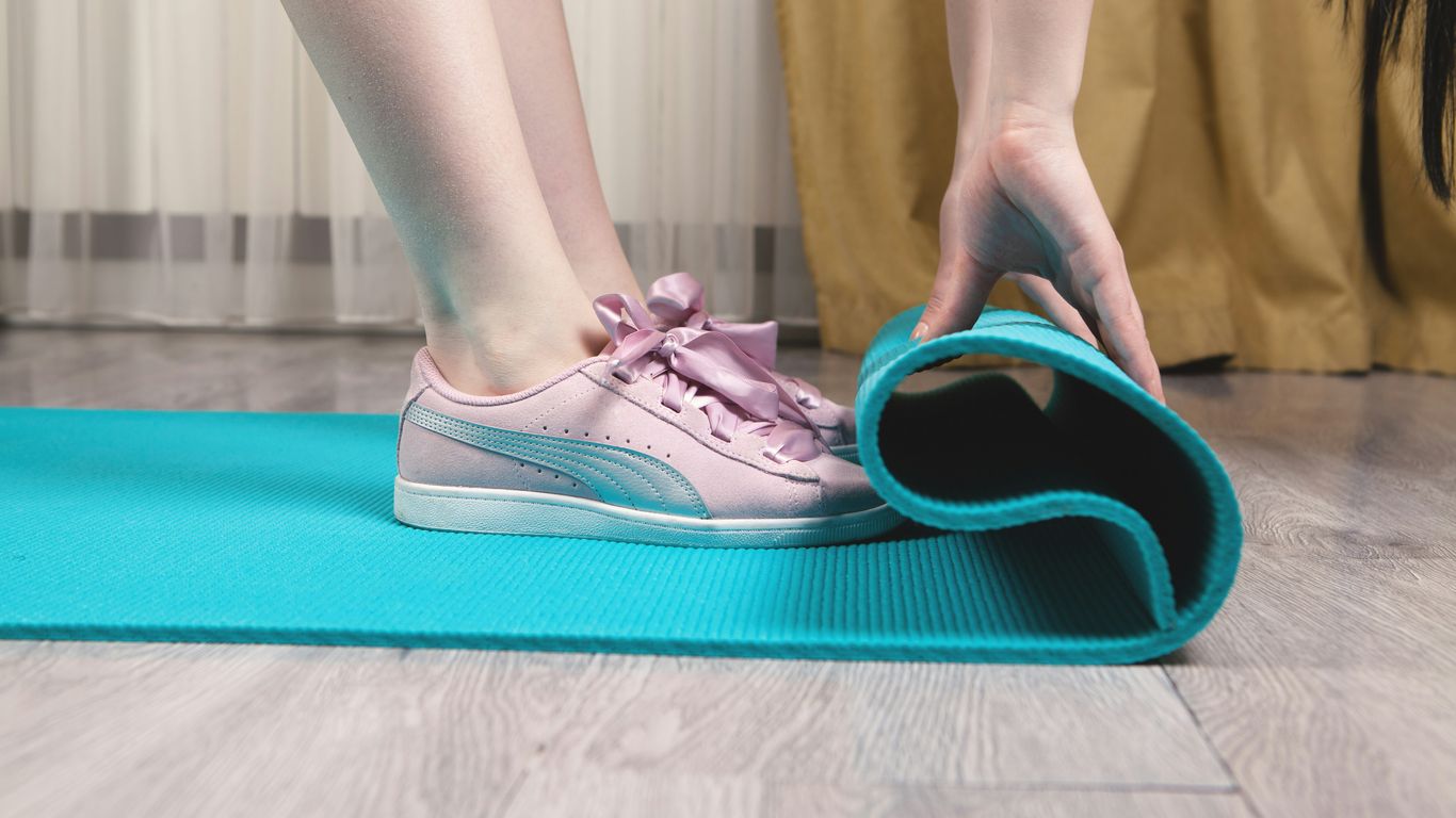 person wearing teal and white nike sneakers