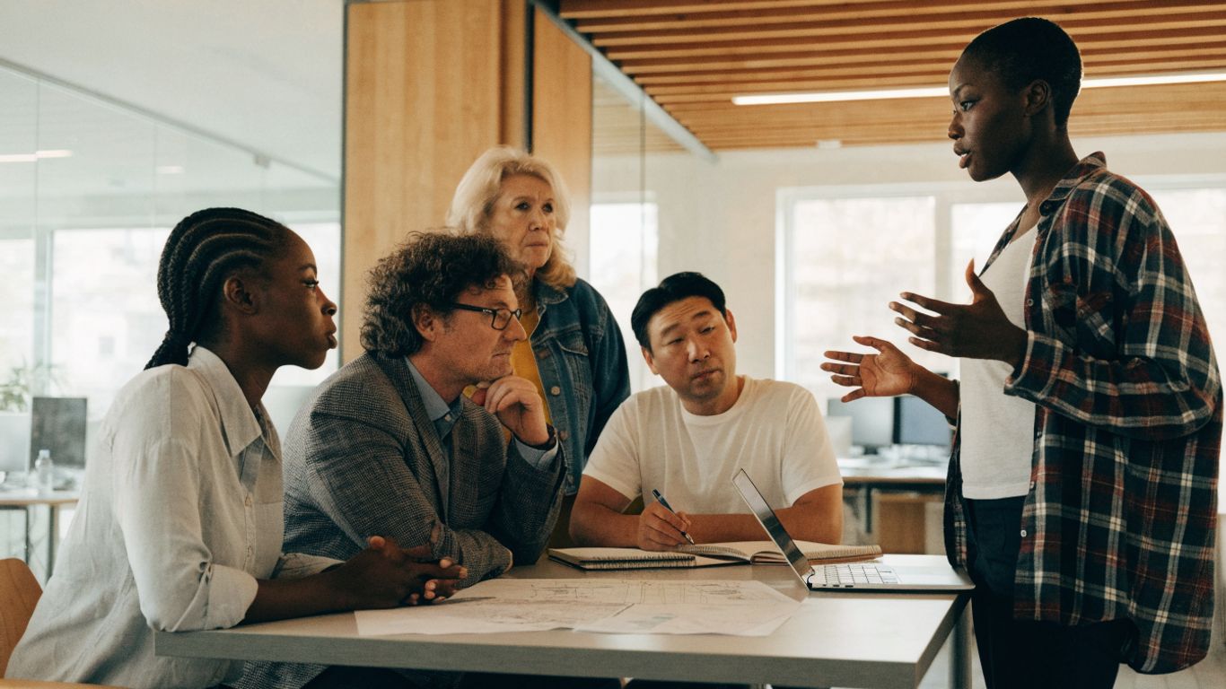 Manager and teammates reviewing a project plan