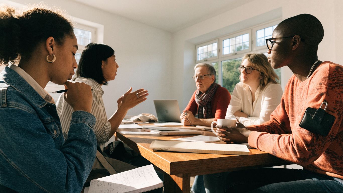 Team members learning together around a shared table