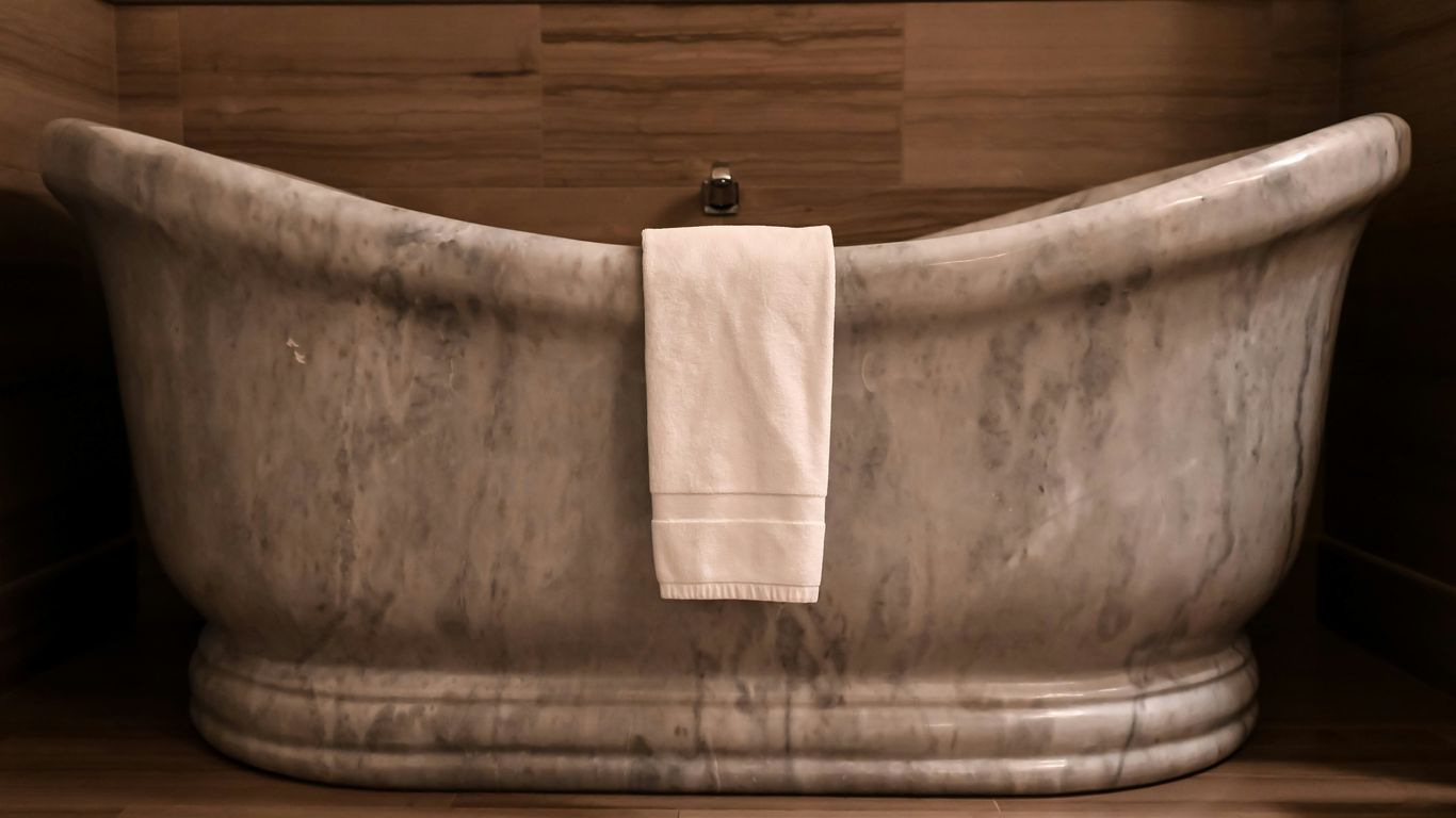 Stone bathtub interior being carefully shaped