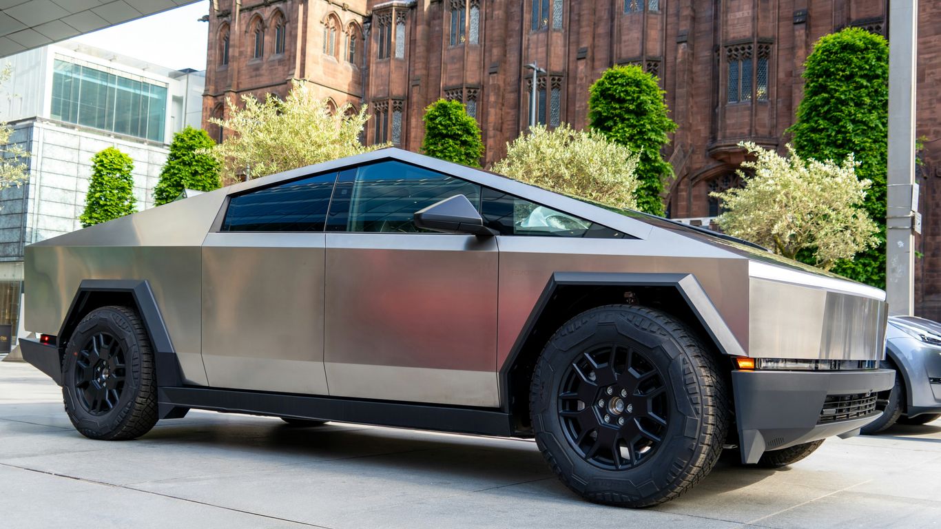 a futuristic car parked in front of a building