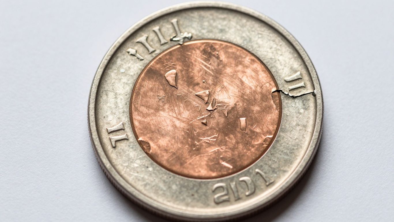 A worn coin showing extreme missing clad layers