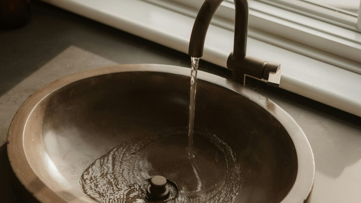 Calm bathroom with sculptural stone basin