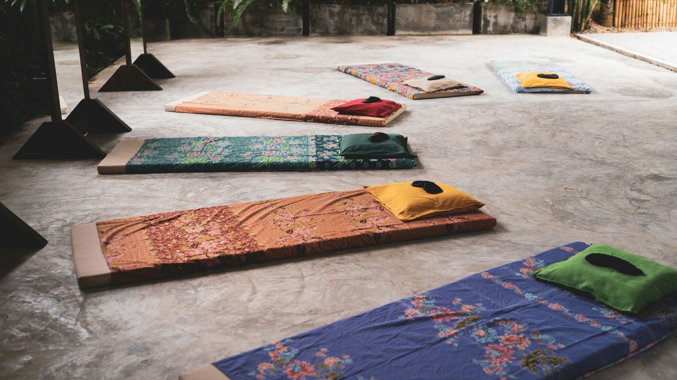 A group of yoga mats sitting on top of a cement floor