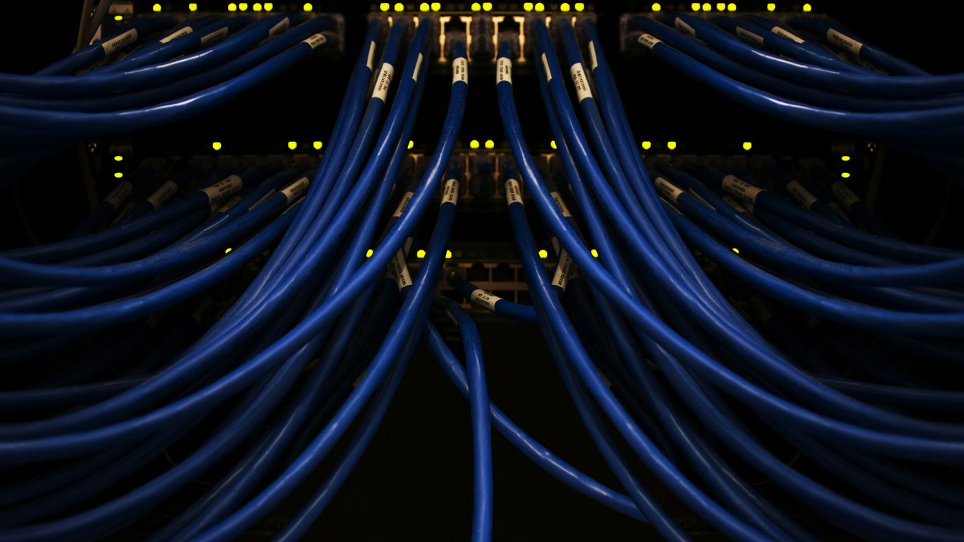 Technician adjusting high density quantum control electronics