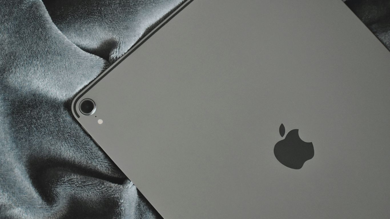 silver Apple iPad on grey textile