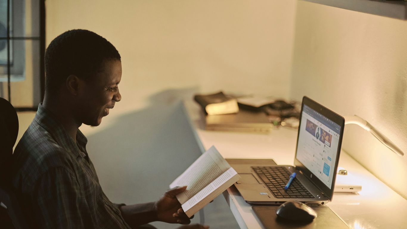 man in black dress shirt using laptop computer